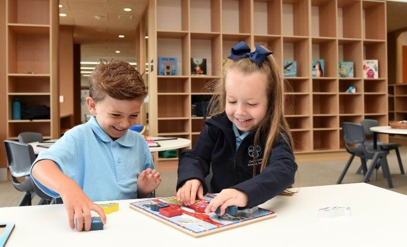 Two primary school students in a classroom Two primary school students in a classroom