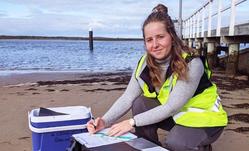 Woman in high vis clothing monitoring sea water quality Woman in high vis clothing monitoring sea water quality